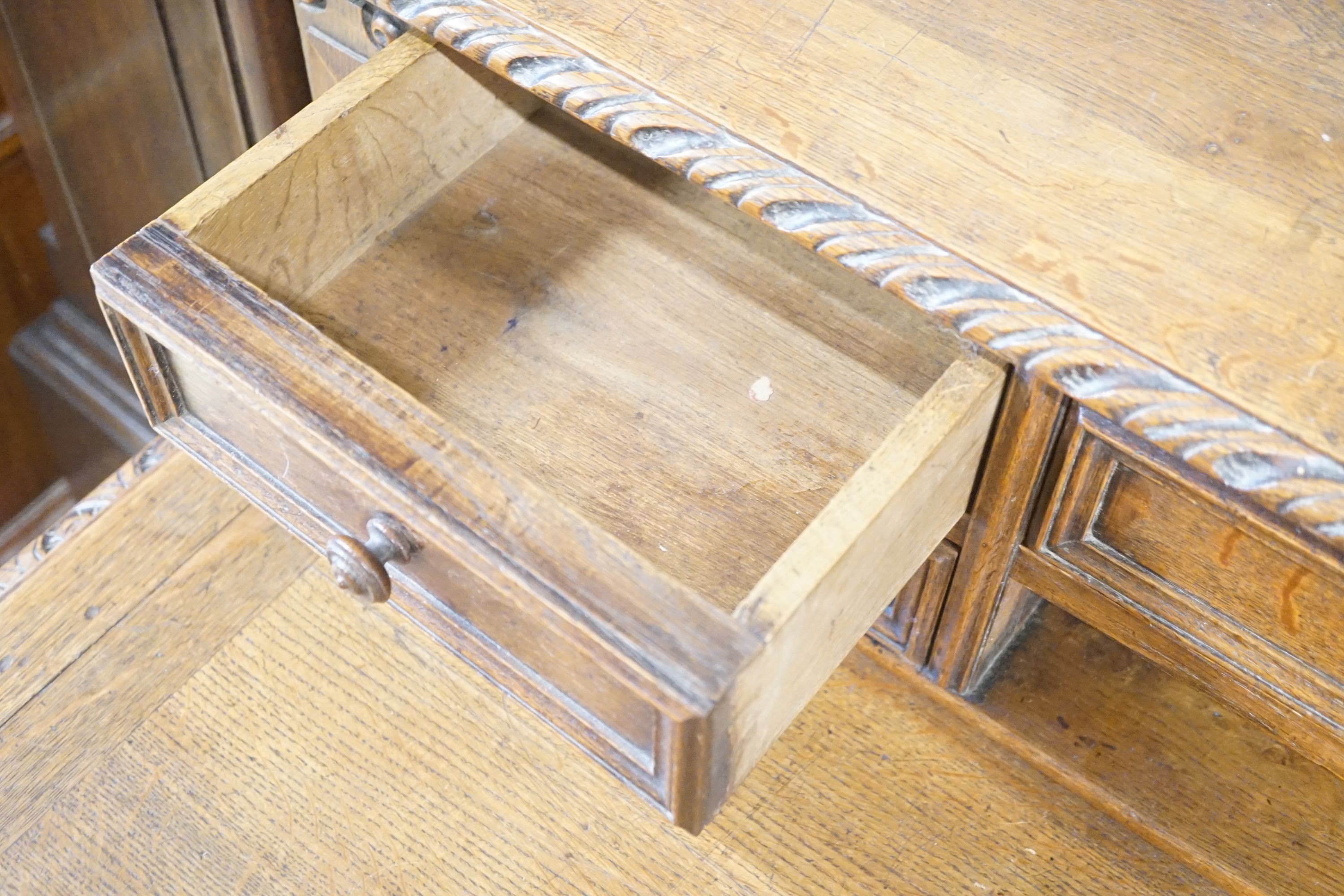 A Victorian carved oak kneehole desk, width 124cm depth 69cm height 110cm